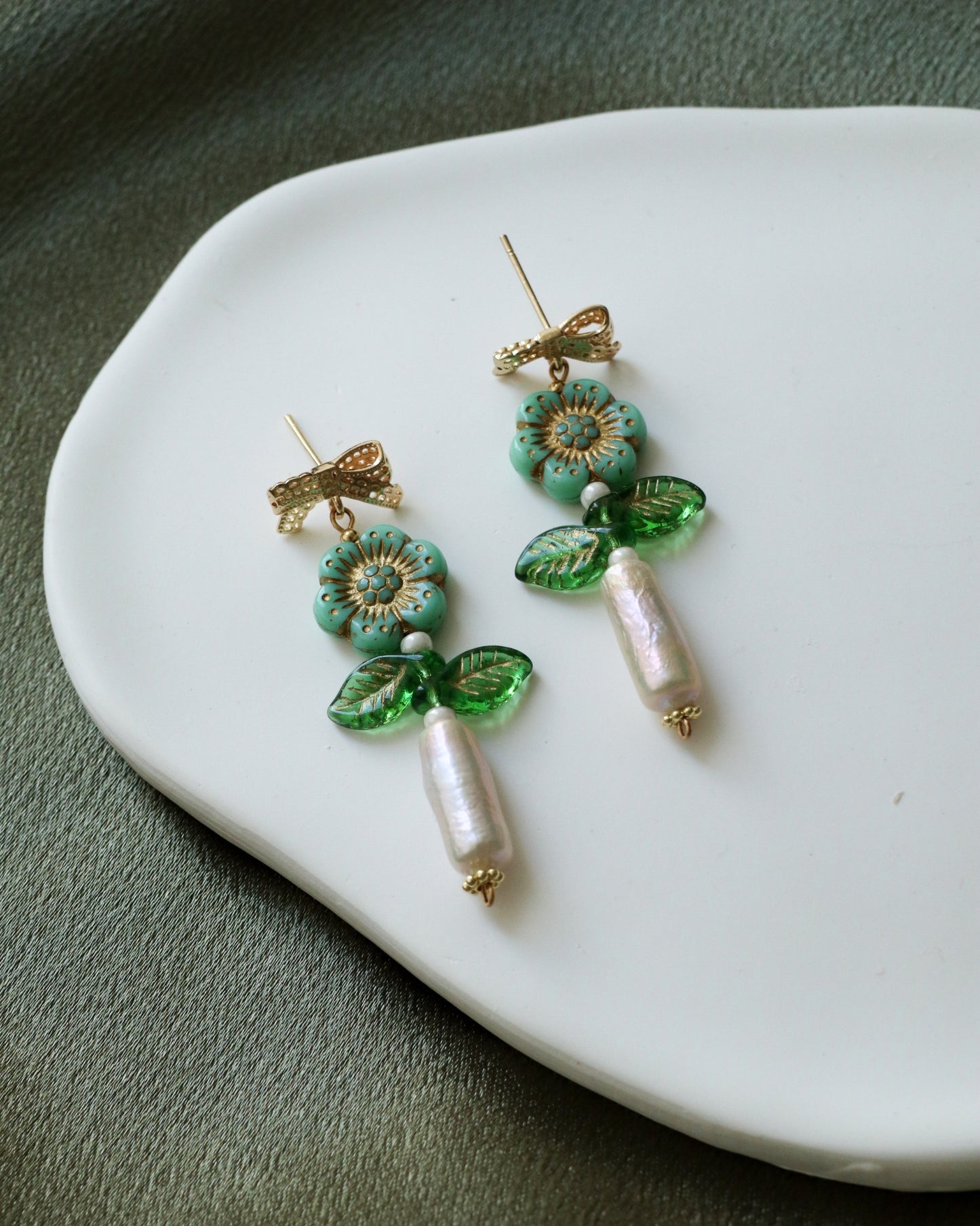 close up of dangling flower earrings