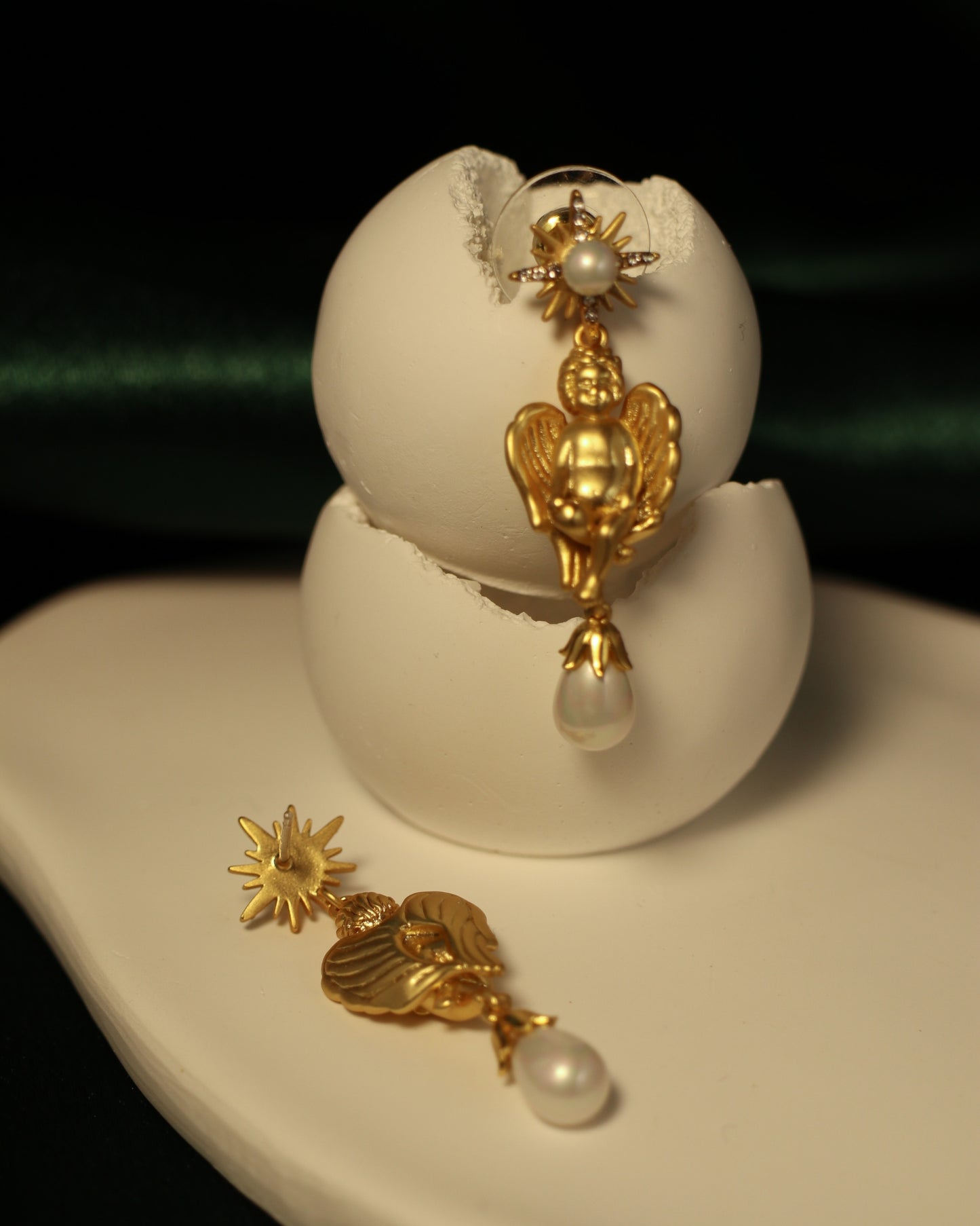 cherub gold pearl drop earrings close up