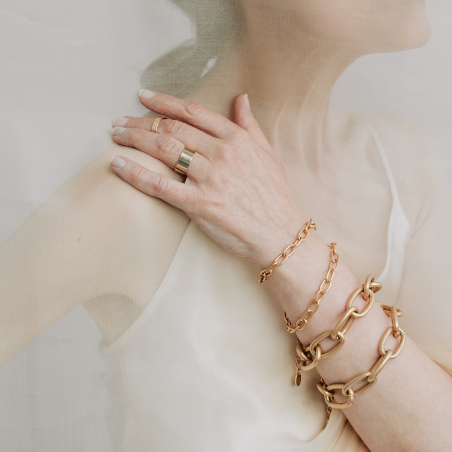 Woman wearing four bracelets on hand