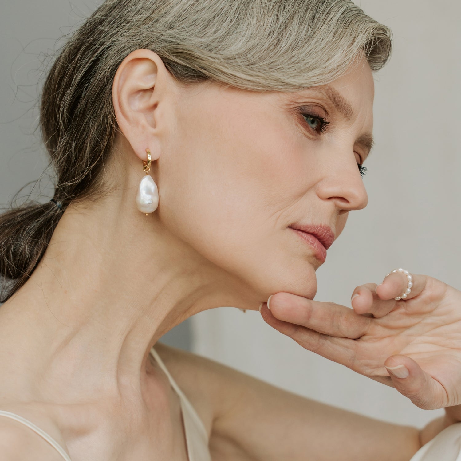 women wearing baroque pearl earrings