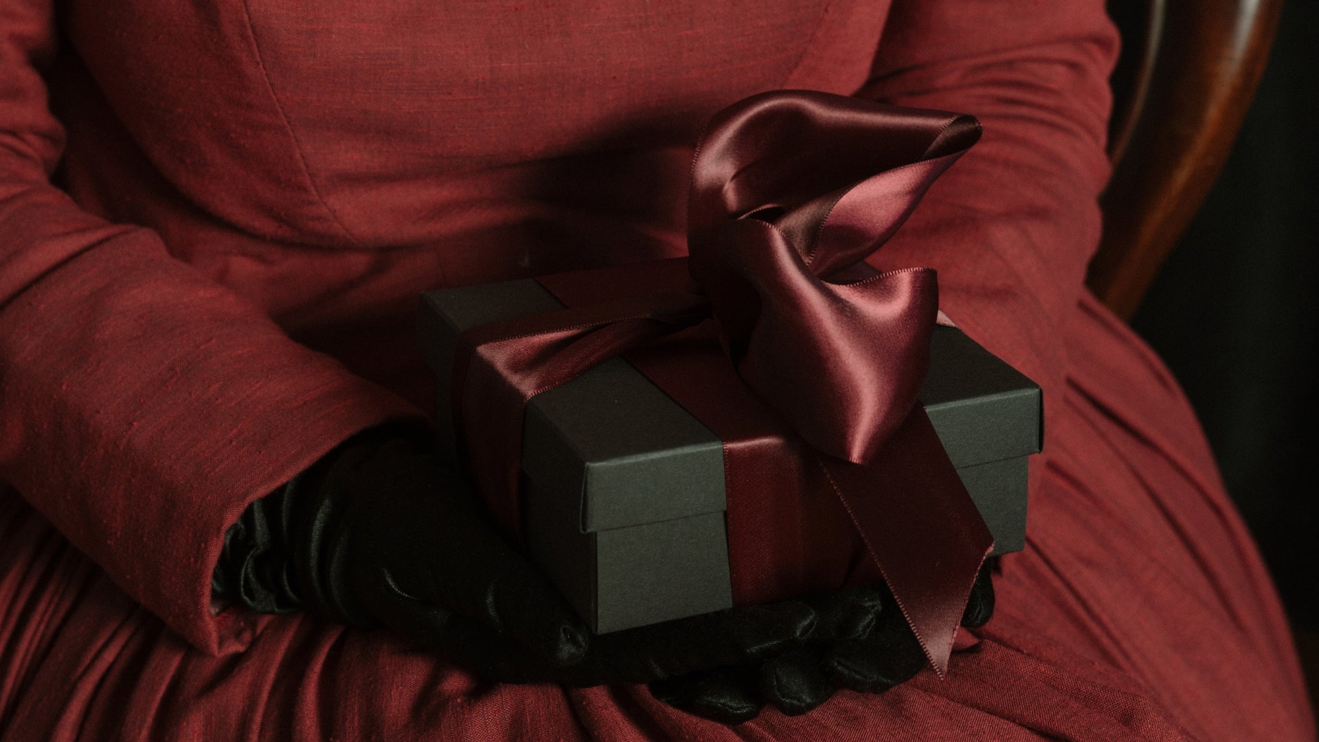 gift box with red ribbon on lap