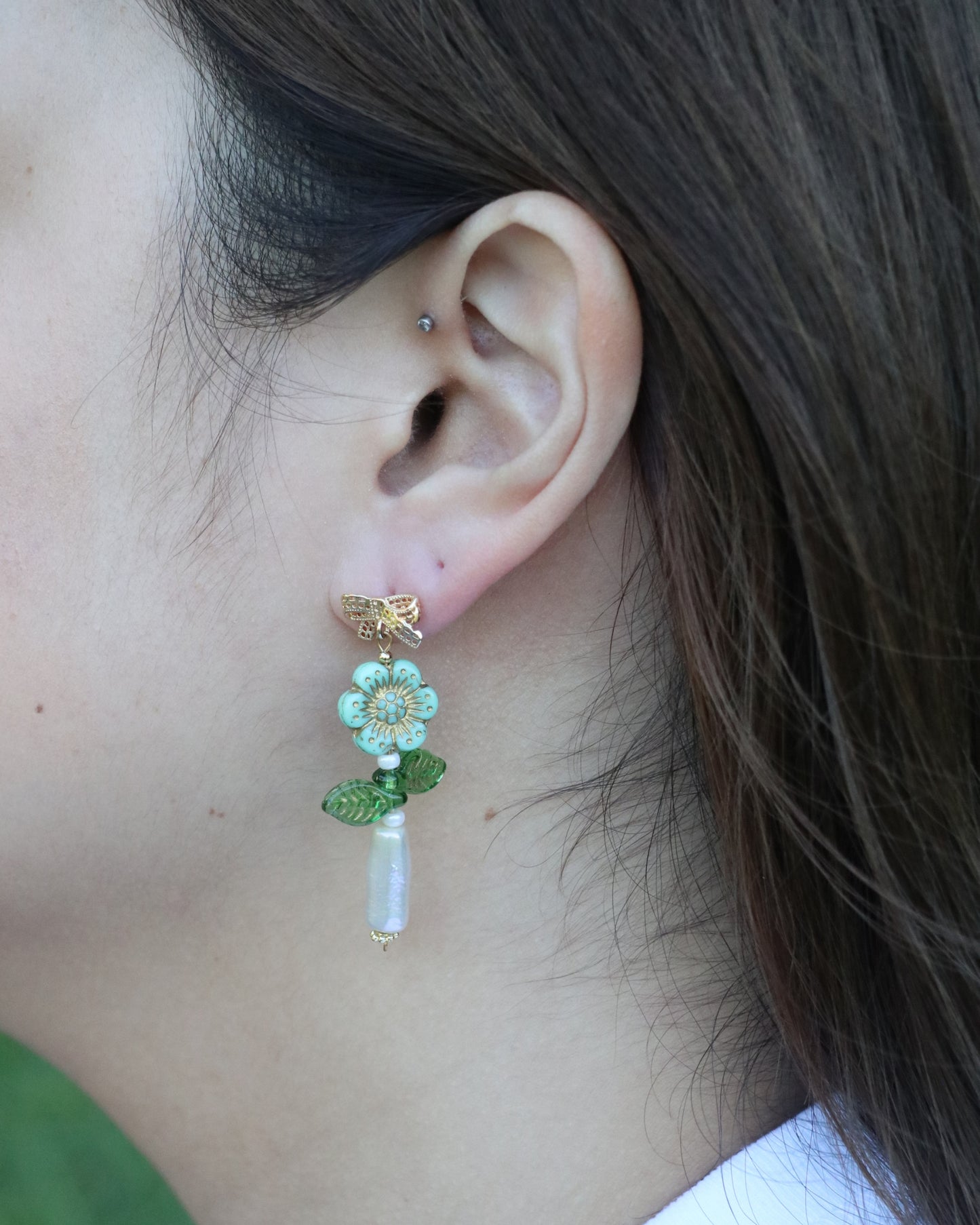 woman wearing dangling flower earrings