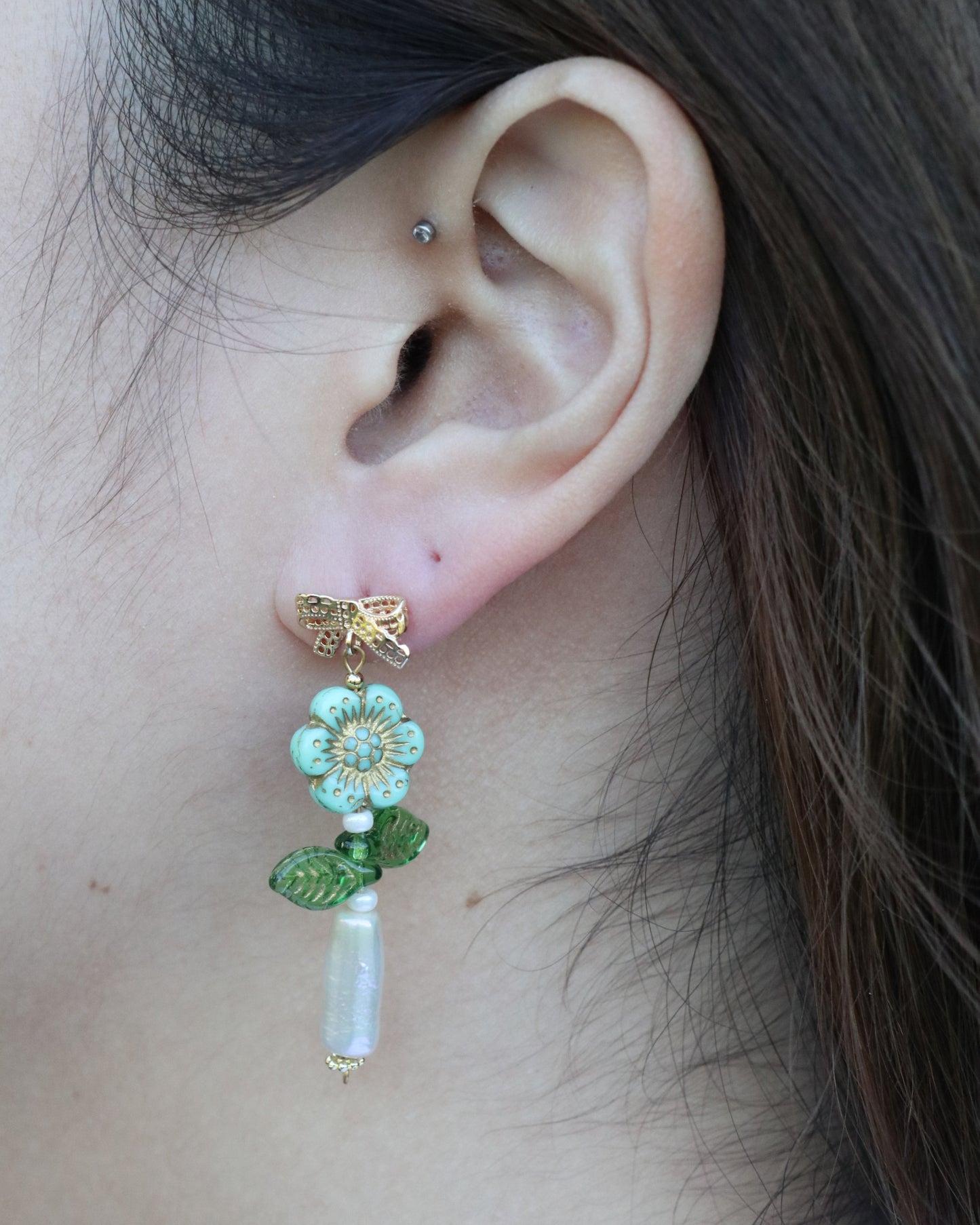 woman wearing dangling flower earrings