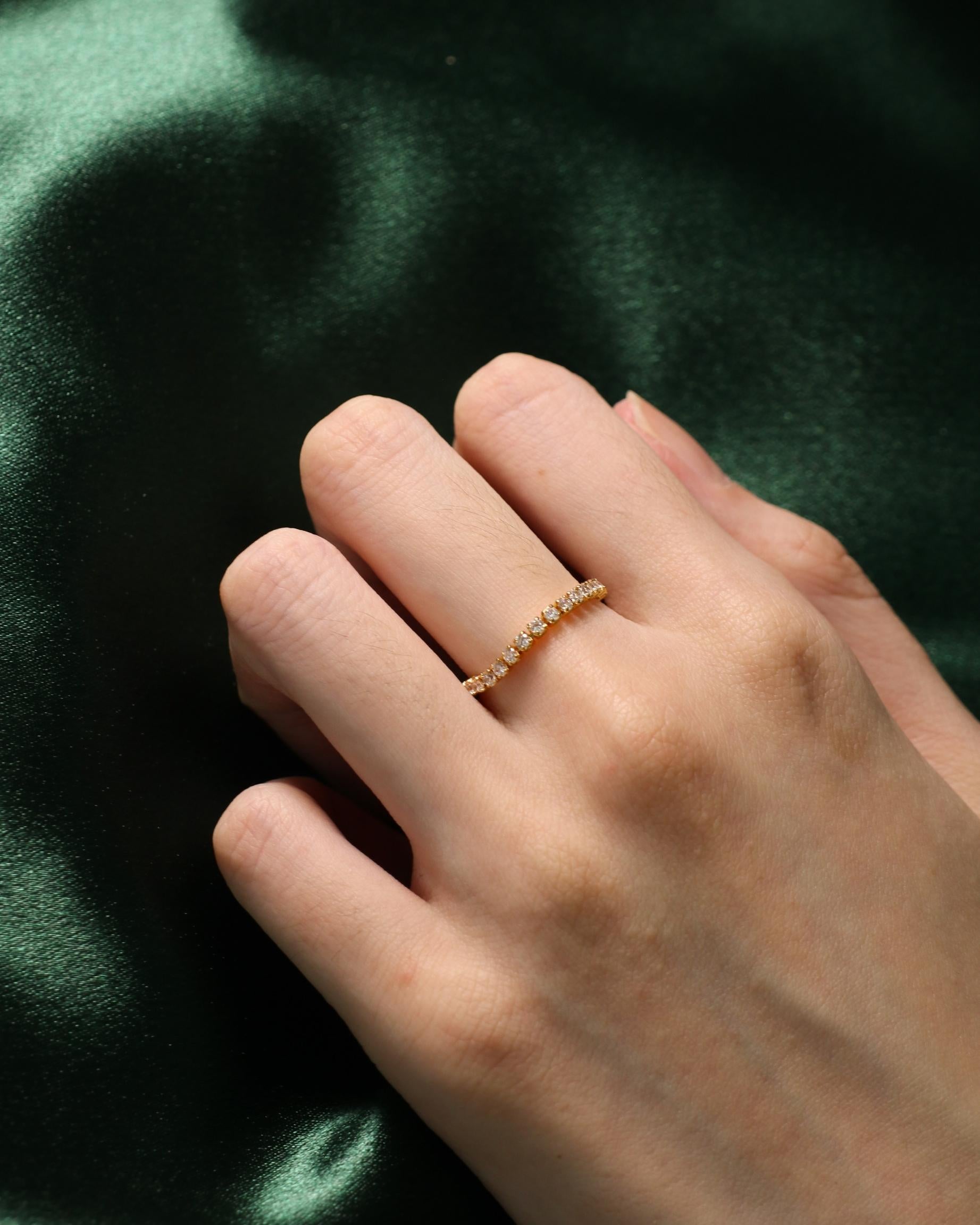 woman wearing dainty zirconia ring