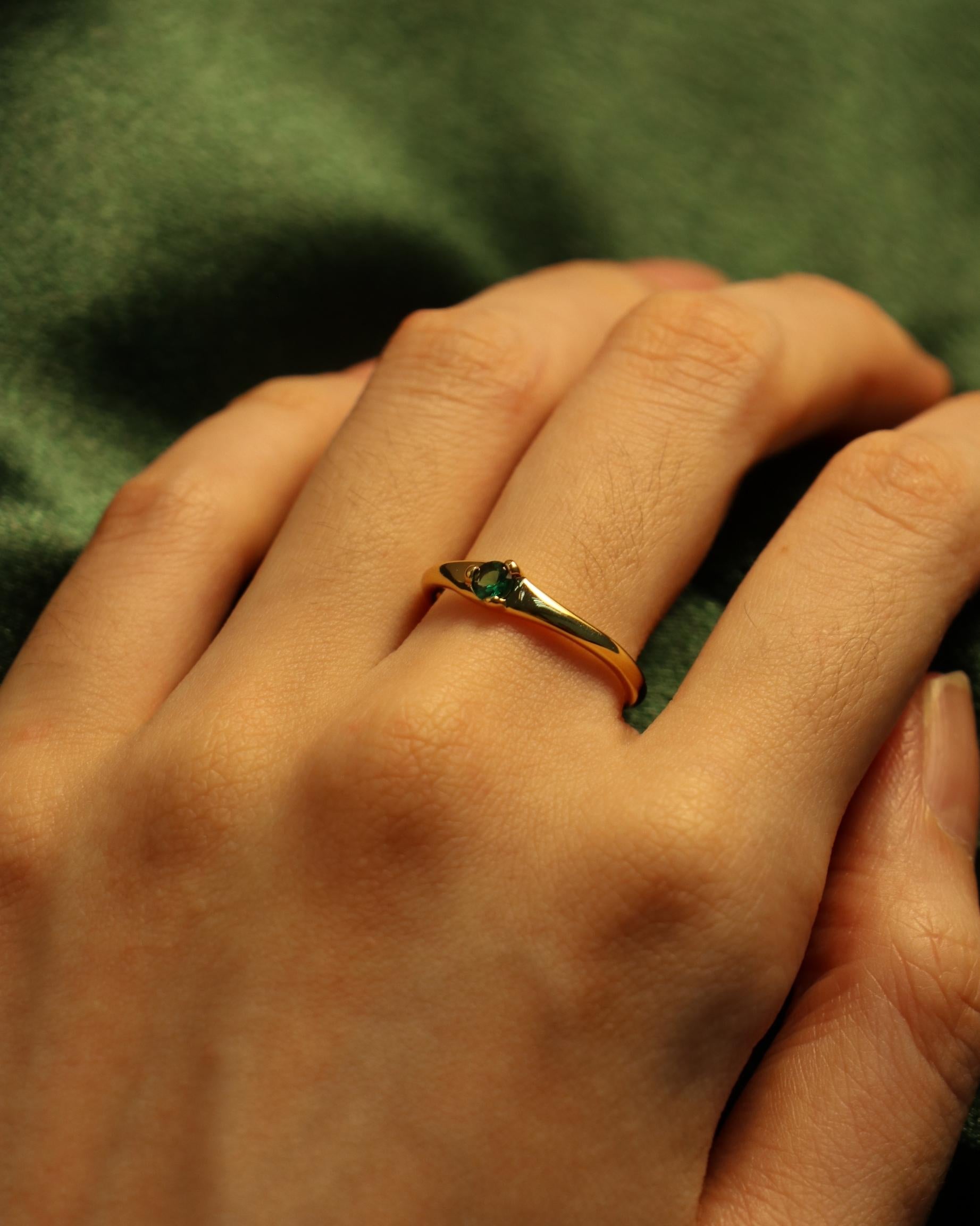 model wearing green gemstone ring