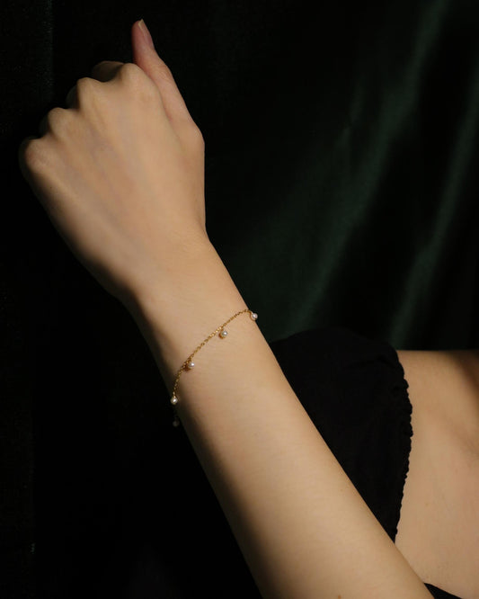 model wearing dainty pearl bracelet
